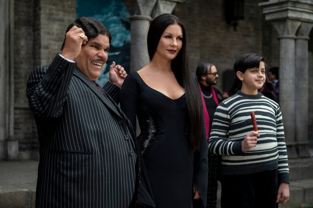 (L to R) Luis Guzmán as Gomez Addams, Catherine Zeta-Jones as Morticia Addams, Issac Ordonez as Pugsley Addams in episode 105 of Wednesday. Cr.  © 2022