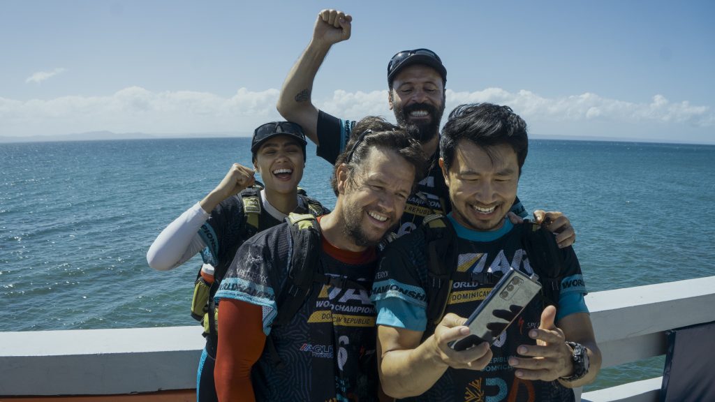 Nathalie Emmanuel as Olivia, Mark Wahlberg as Michael, Ali Suliman as Chik and Simu Liu as Leo in Arthur The King. Photo Credit: Carlos Rodriguez