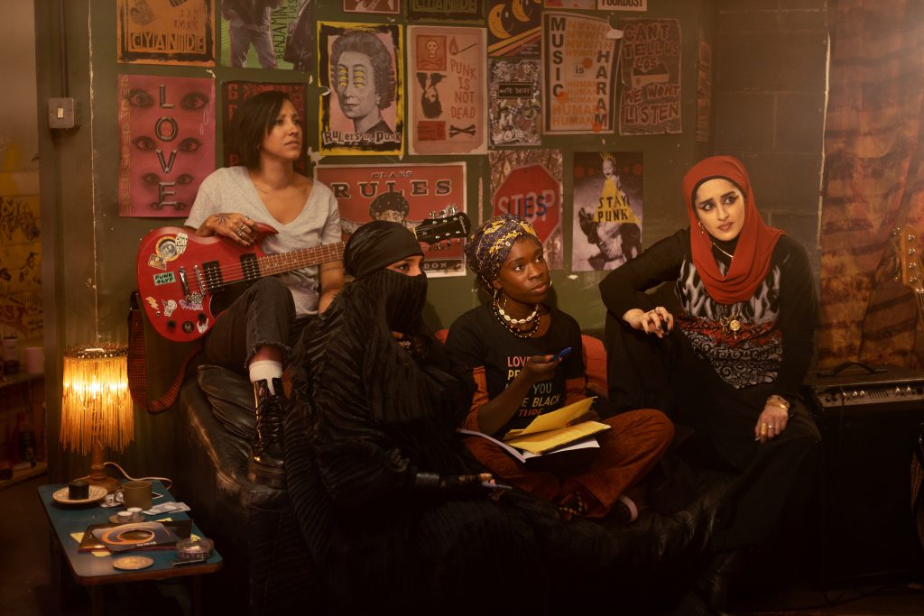 We Are Lady Parts -- Episode 201 -- Pictured: (l-r) Sarah Kameela Impey as Saira, Lucie Shorthouse as Momtaz, Faith Omole as Bisma, Juliette Motamed as Ayesha— (Photo by: Saima Khalid/Peacock/NBC Internatiional/C4)