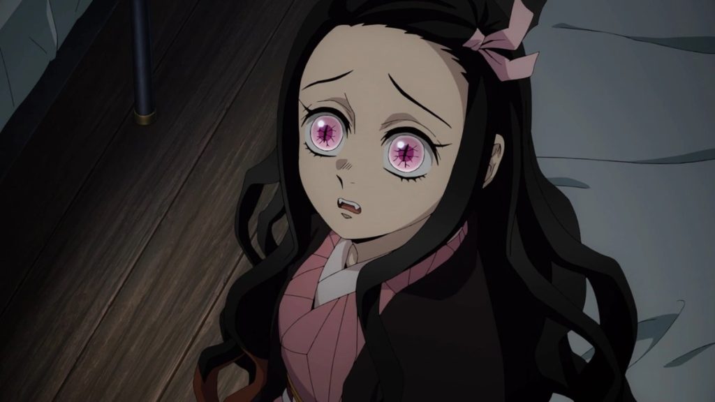 Demon Slayer: Kimetsu no Yaiba - Hashira Training Arc Ep. 1 "To Defeat Muzan Kibutsuji" screenshot showing a worried Nezuko sitting on a bed.