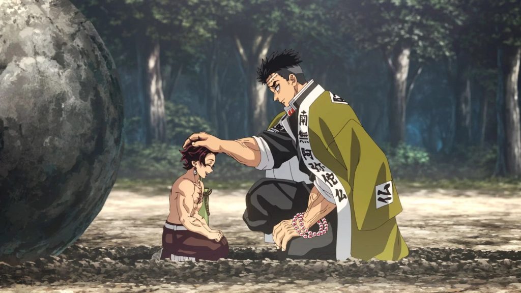 Demon Slayer: Kimetsu no Yaiba - Hashira Training Arc Ep. 7 "Stone Hashira Gyomei Himejima" screenshot showing Gyomei patting a kneeling Tanjiro on the head.