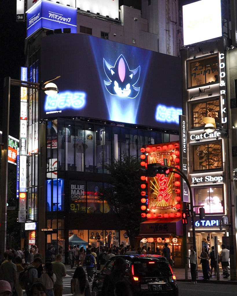 Sonic the Hedgehog 3 projections featuring images of Sonic, Shadow, and the classic Robotnik icon appear in multiple cities and locations around the world, as seen here at Shinjuku, Tokyo.