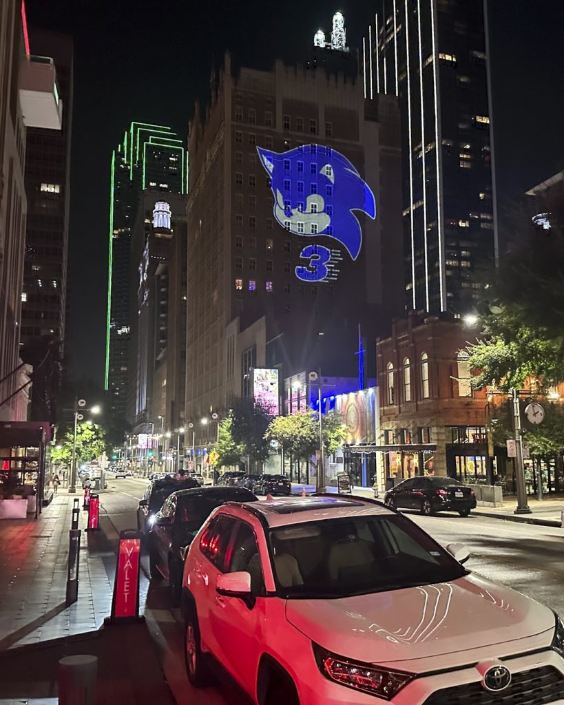 Sonic the Hedgehog 3 projections featuring images of Sonic, Shadow, and the classic Robotnik icon appear in multiple cities and locations around the world, as seen here at The KIrby, Dallas, Tx.