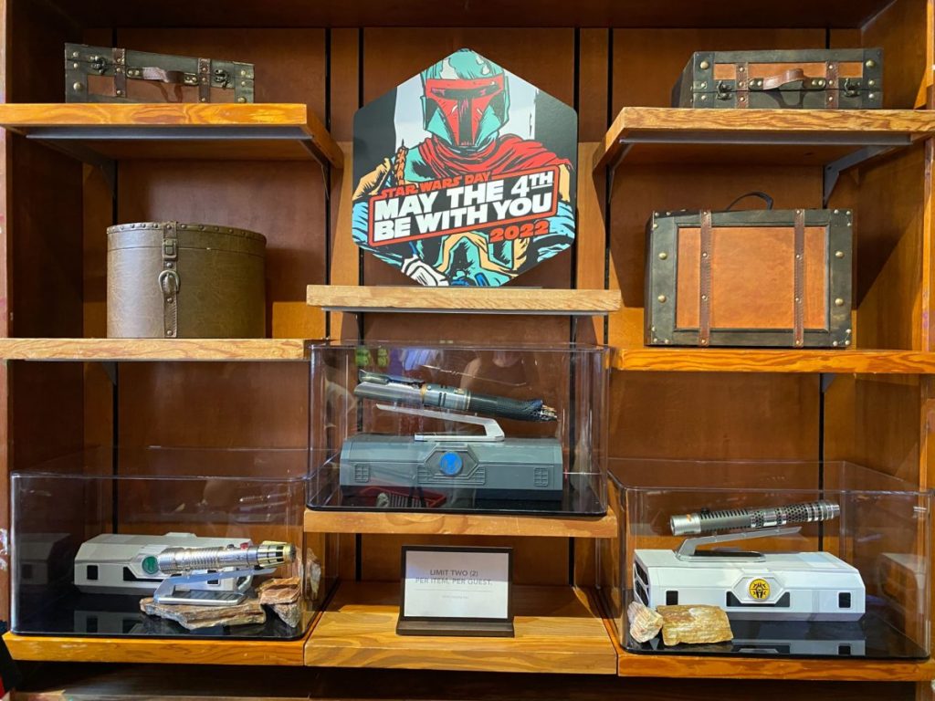 A shelf at Dok-Ondar's Den of Antiquities at Star Wars: Galaxy's Edge at Disney's Hollywood Studios, showing the new lightsabers for sale.